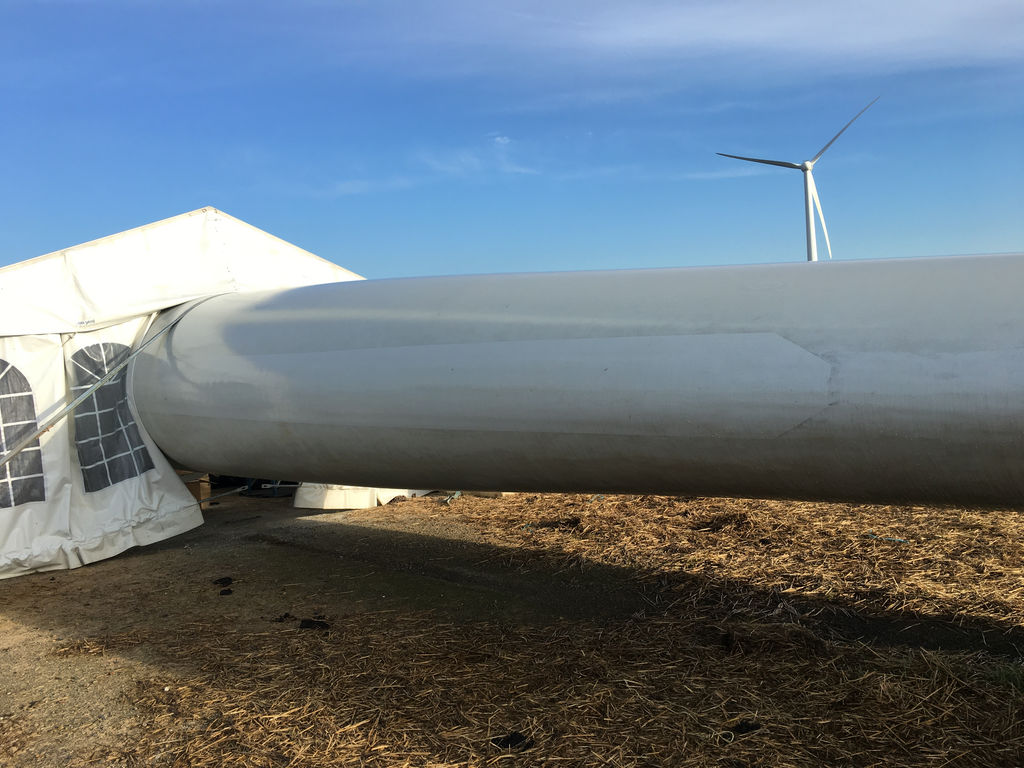 Technicians carrying out rope access blade repair on a turbine blade